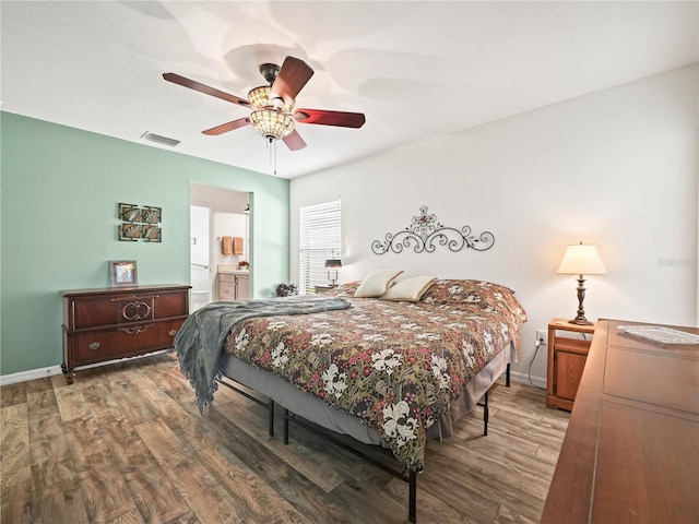 bedroom featuring ensuite bath, ceiling fan, and wood-type flooring