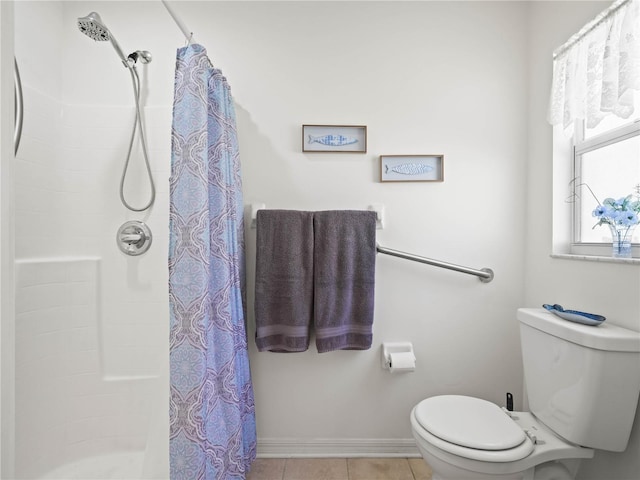 bathroom featuring tile patterned flooring, a shower with curtain, and toilet