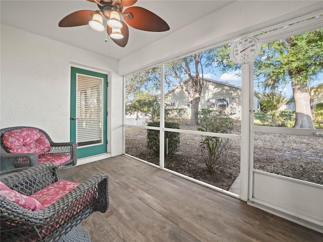 sunroom / solarium featuring plenty of natural light and ceiling fan