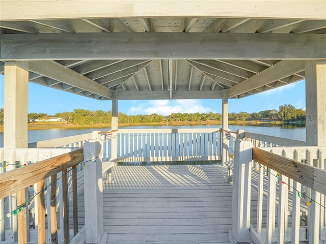 view of dock with a gazebo and a deck with water view