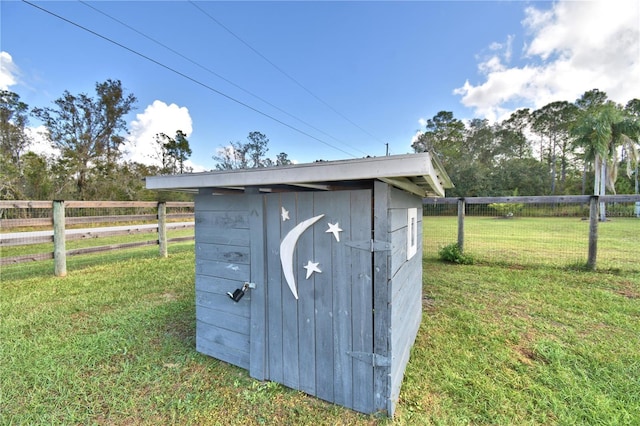 view of outbuilding featuring a yard