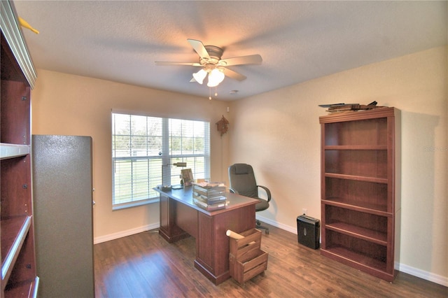 office area with ceiling fan, dark hardwood / wood-style flooring, and a textured ceiling