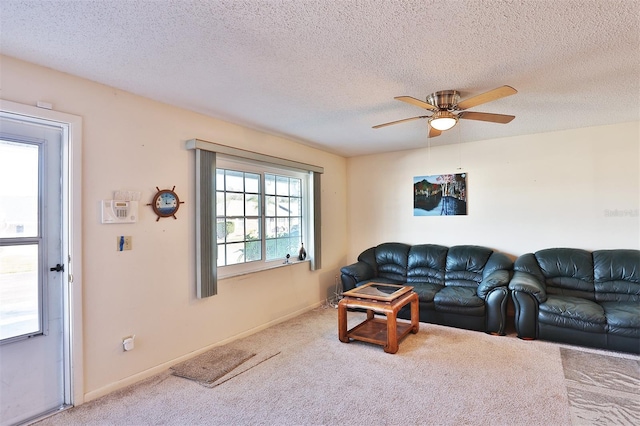 carpeted living room featuring a textured ceiling and ceiling fan