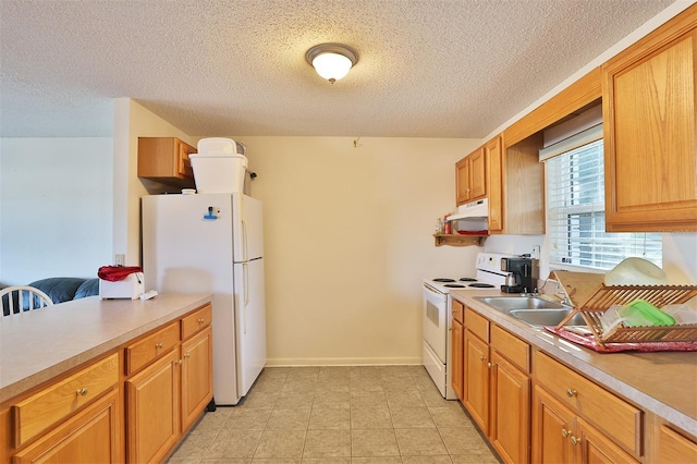 kitchen with sink, a textured ceiling, and white appliances