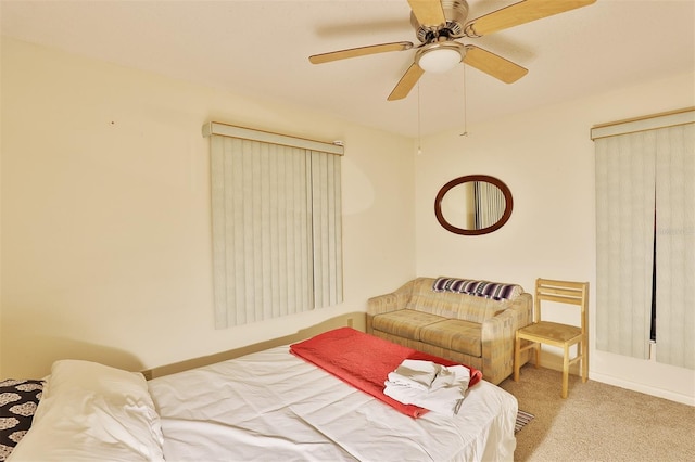 bedroom with ceiling fan and light carpet