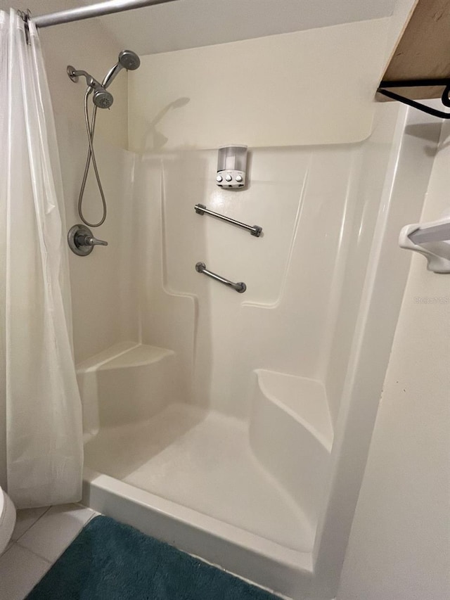 bathroom featuring walk in shower and tile patterned floors