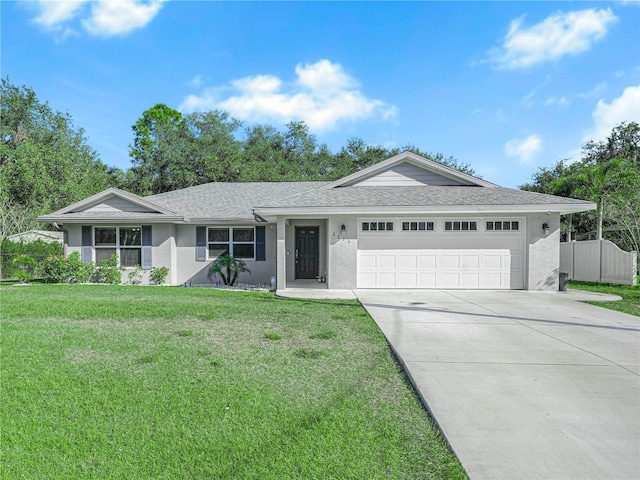 ranch-style home featuring a front lawn and a garage