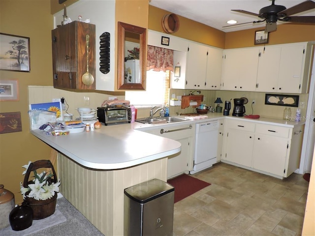 kitchen featuring kitchen peninsula, ceiling fan, white dishwasher, sink, and white cabinetry