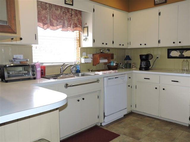 kitchen featuring sink, white cabinetry, decorative backsplash, and dishwasher