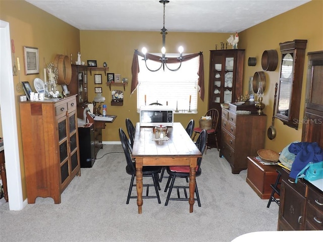 carpeted dining space featuring a notable chandelier