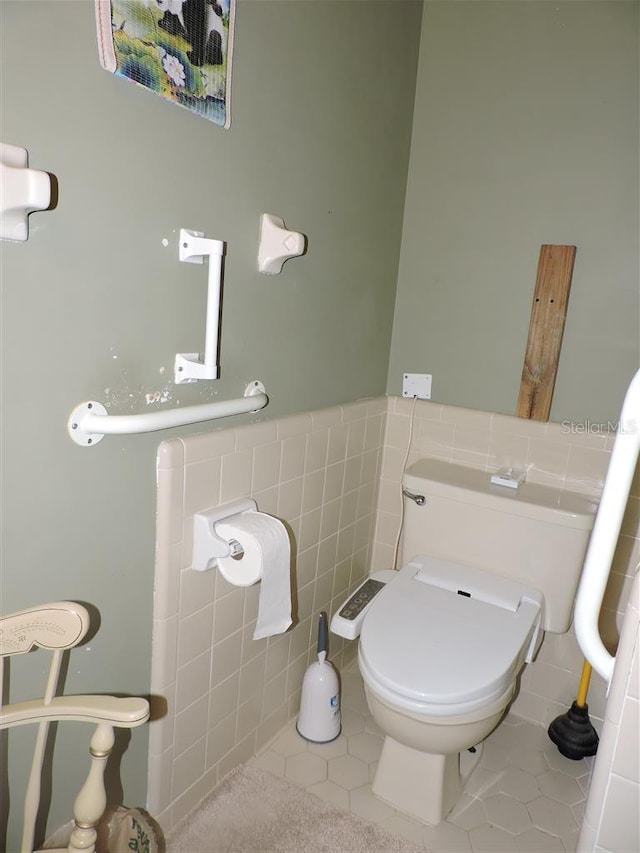 bathroom featuring tile walls, toilet, and tile patterned flooring