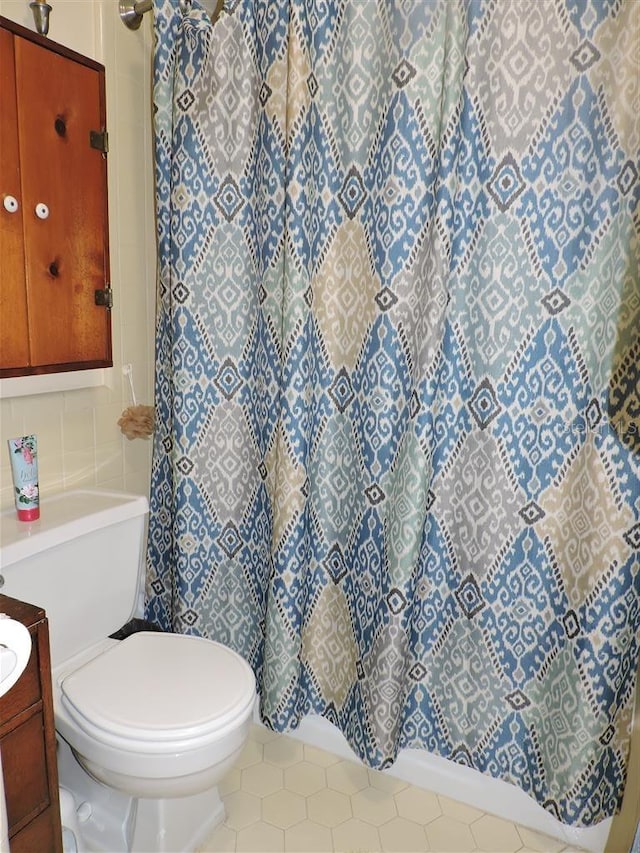 bathroom with tile patterned flooring, vanity, a shower with curtain, backsplash, and toilet