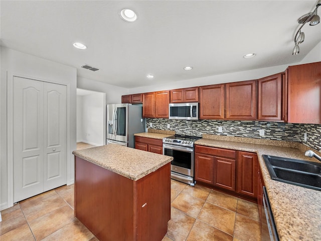 kitchen with sink, stainless steel appliances, decorative backsplash, and a center island