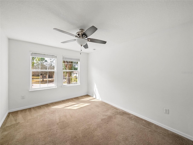 spare room with ceiling fan, carpet flooring, and a textured ceiling