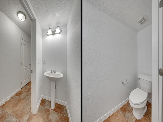 bathroom with a textured ceiling and toilet