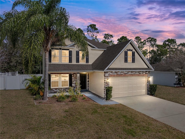 view of front of house with a garage and a lawn