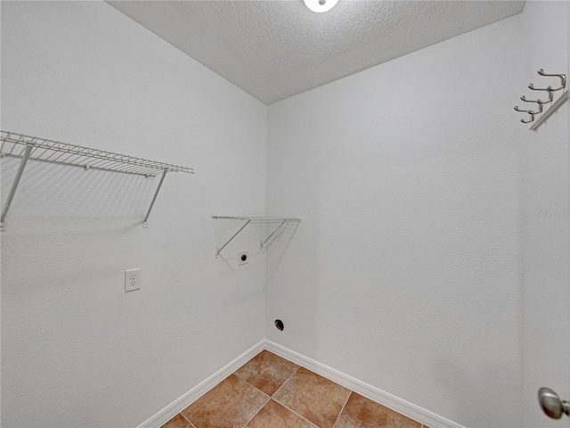 washroom with a textured ceiling and electric dryer hookup