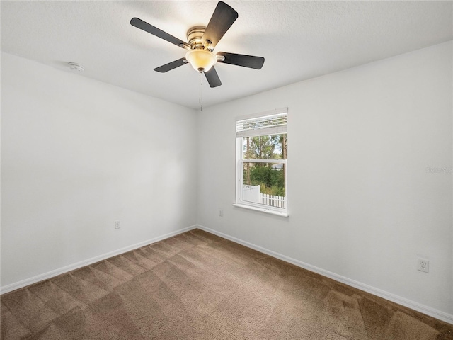 carpeted spare room with ceiling fan and a textured ceiling