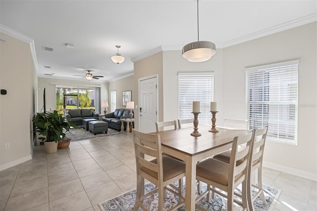 dining area with ceiling fan, crown molding, and light tile patterned flooring