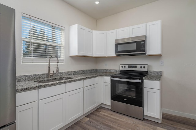 kitchen featuring sink, white cabinets, and appliances with stainless steel finishes