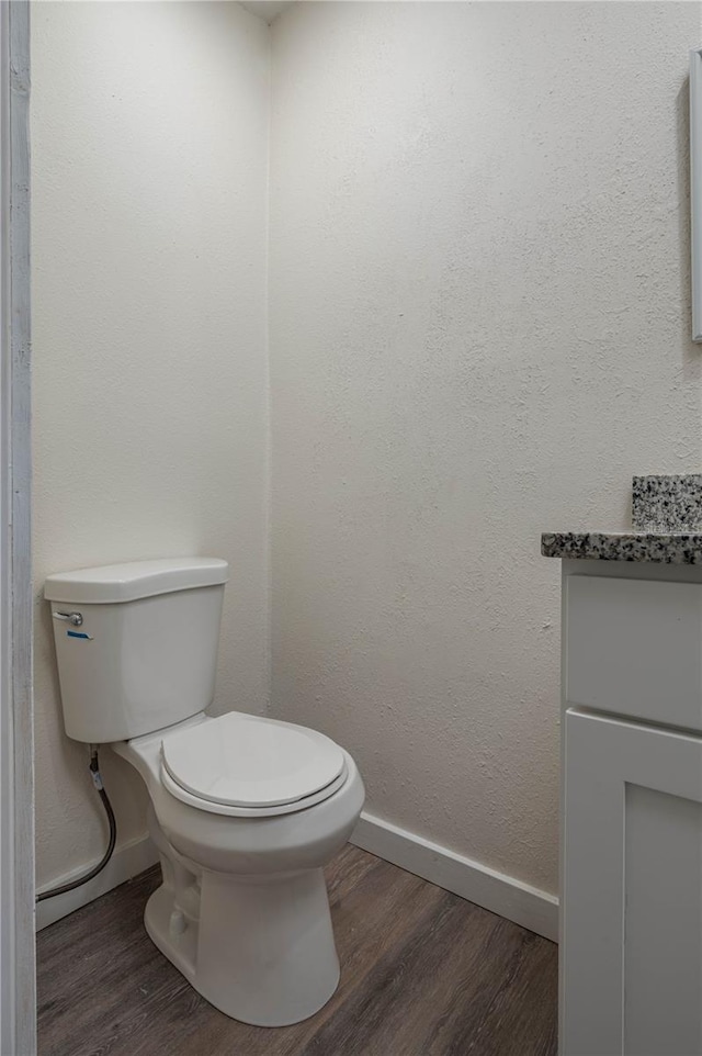 bathroom featuring hardwood / wood-style floors, vanity, and toilet