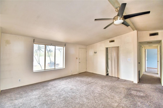 unfurnished room featuring ceiling fan, vaulted ceiling with beams, and carpet floors