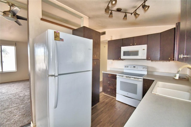 kitchen featuring ceiling fan, white appliances, lofted ceiling, dark brown cabinetry, and sink