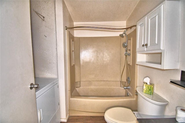 bathroom featuring toilet and  shower combination