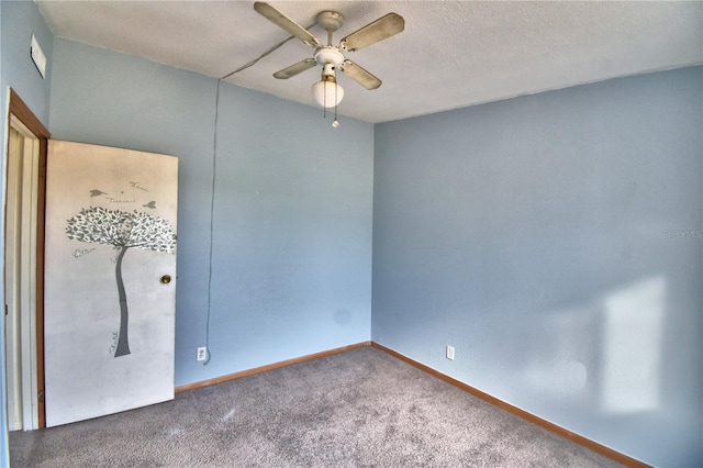 spare room with ceiling fan, carpet, and a textured ceiling