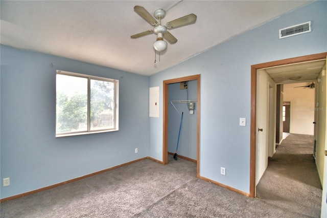 unfurnished bedroom with ceiling fan, vaulted ceiling, carpet, and a closet