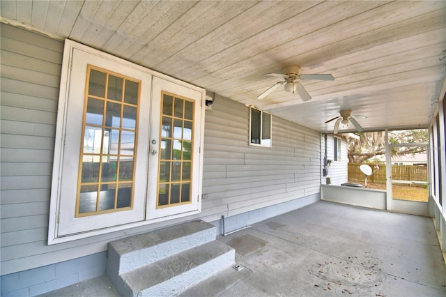 unfurnished sunroom featuring ceiling fan and wooden ceiling