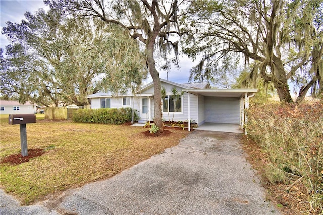 ranch-style house with a front lawn and a carport