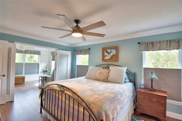 bedroom featuring ceiling fan, crown molding, and wood finished floors