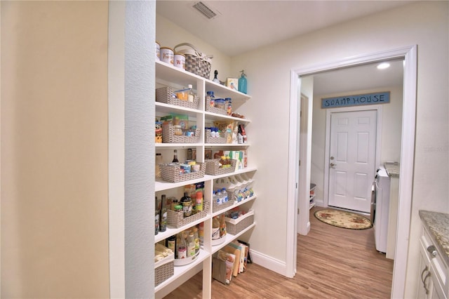 pantry featuring visible vents and separate washer and dryer