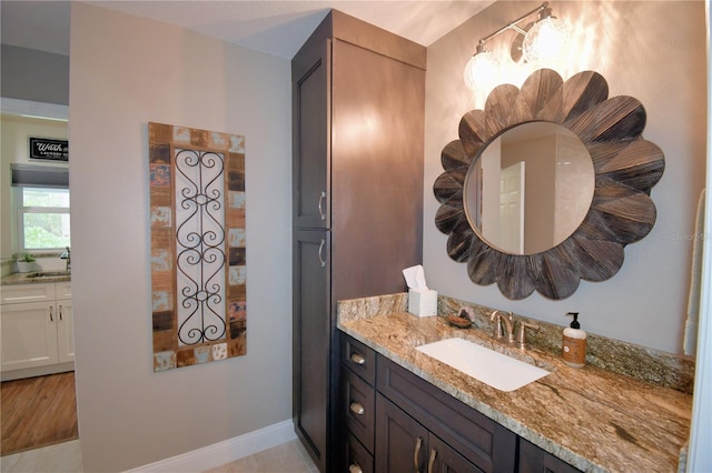 bathroom featuring vanity and baseboards