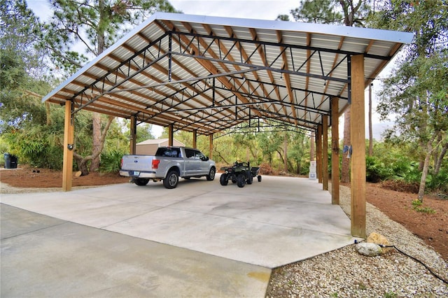 view of car parking with a detached carport and driveway