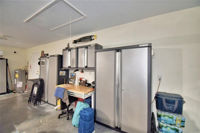 garage with water heater and freestanding refrigerator