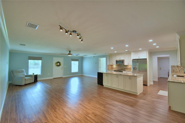 112 Reedy Creek Dr, Frostproof, FL 33843 - kitchen with stainless steel appliances, crown molding, a kitchen island, open floor plan, and recessed lighting