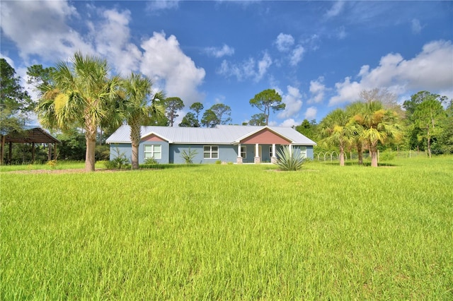 112 Reedy Creek Dr, Frostproof, FL 33843 - view of front of home with a metal roof and a front yard