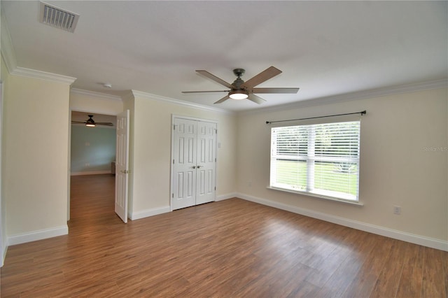 112 Reedy Creek Dr, Frostproof, FL 33843 - unfurnished bedroom with wood finished floors, a closet, ornamental molding, and a ceiling fan
