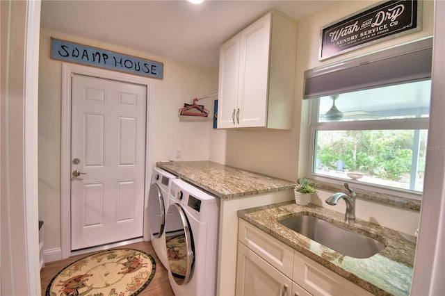 112 Reedy Creek Dr, Frostproof, FL 33843 - laundry room with washing machine and clothes dryer, cabinet space, and wood finished floors