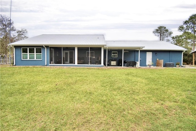 112 Reedy Creek Dr, Frostproof, FL 33843 - back of house with a sunroom, a yard, ceiling fan, and a metal roof