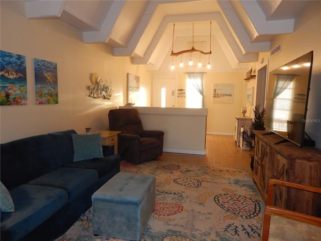 living room featuring high vaulted ceiling and light hardwood / wood-style floors