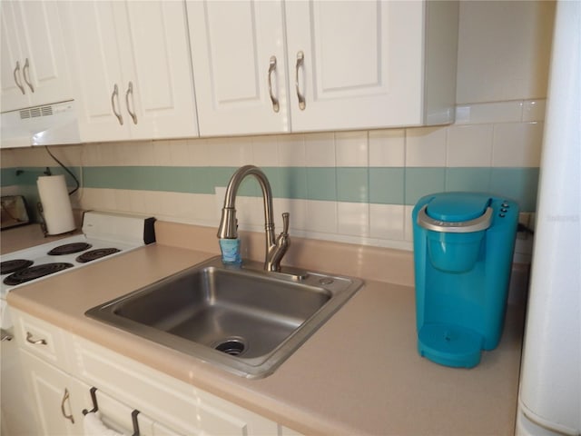 kitchen with white cabinetry, sink, white electric range, and backsplash