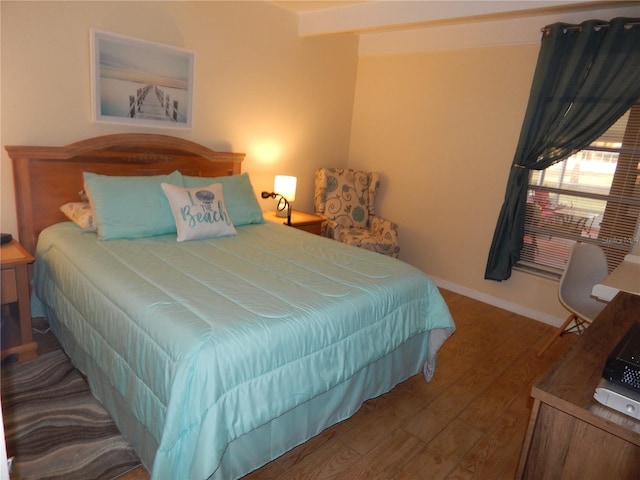 bedroom with dark hardwood / wood-style floors