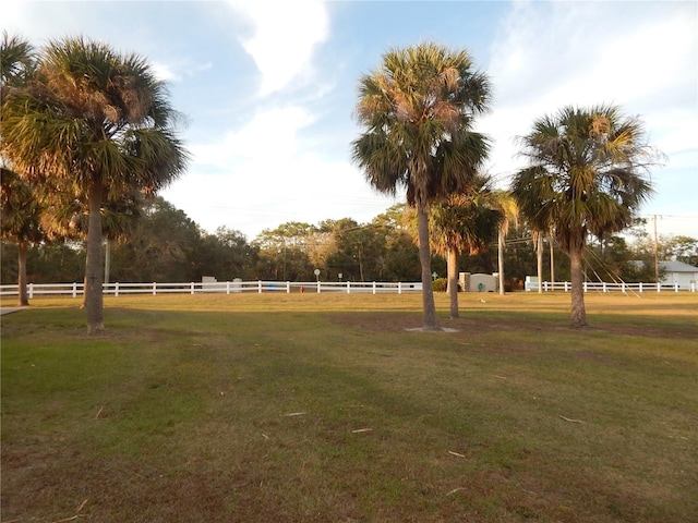 view of home's community featuring a rural view and a lawn