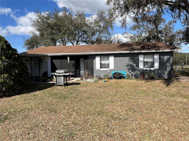 rear view of house with a carport and a lawn