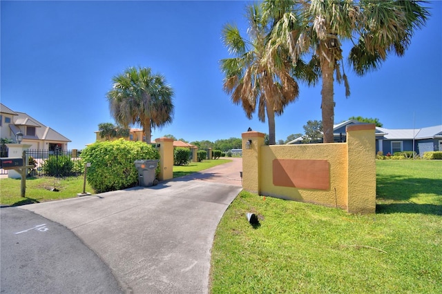 exterior space featuring a lawn and fence