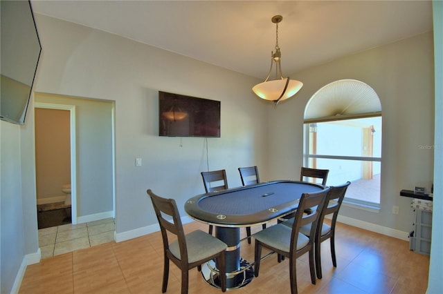 dining space featuring baseboards and light tile patterned flooring