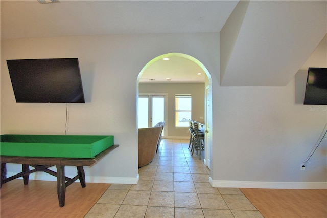 hall with visible vents, baseboards, light tile patterned floors, recessed lighting, and arched walkways